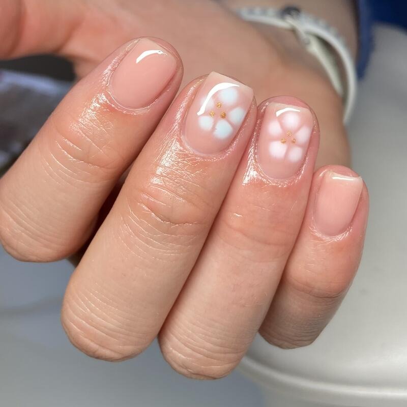 Nude nails with white flower accents