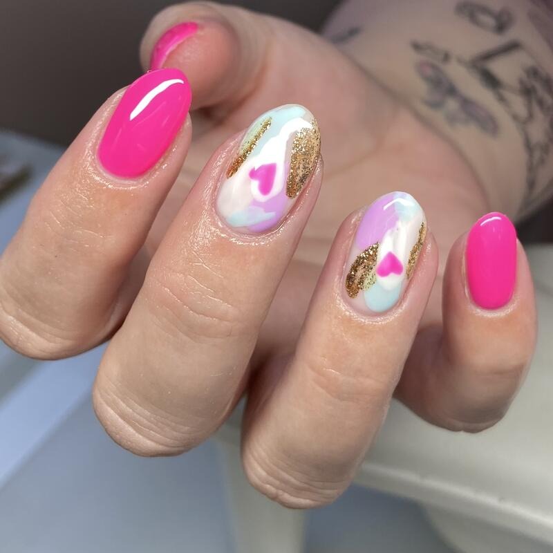 Hot pink nails with marbled heart and gold accents