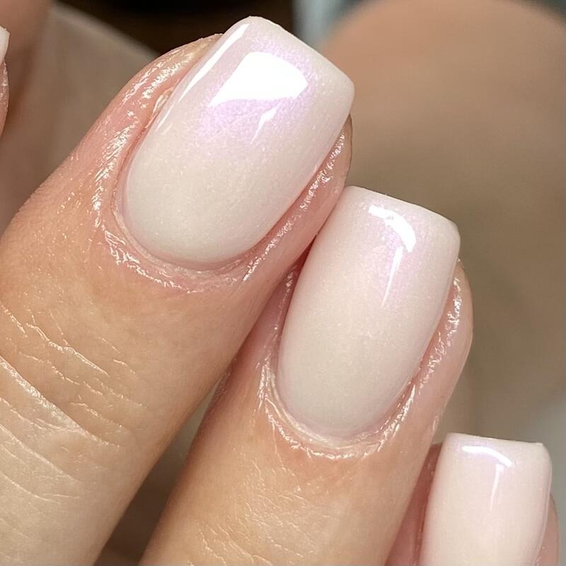 Close-up of a pearly milky BIAB manicure